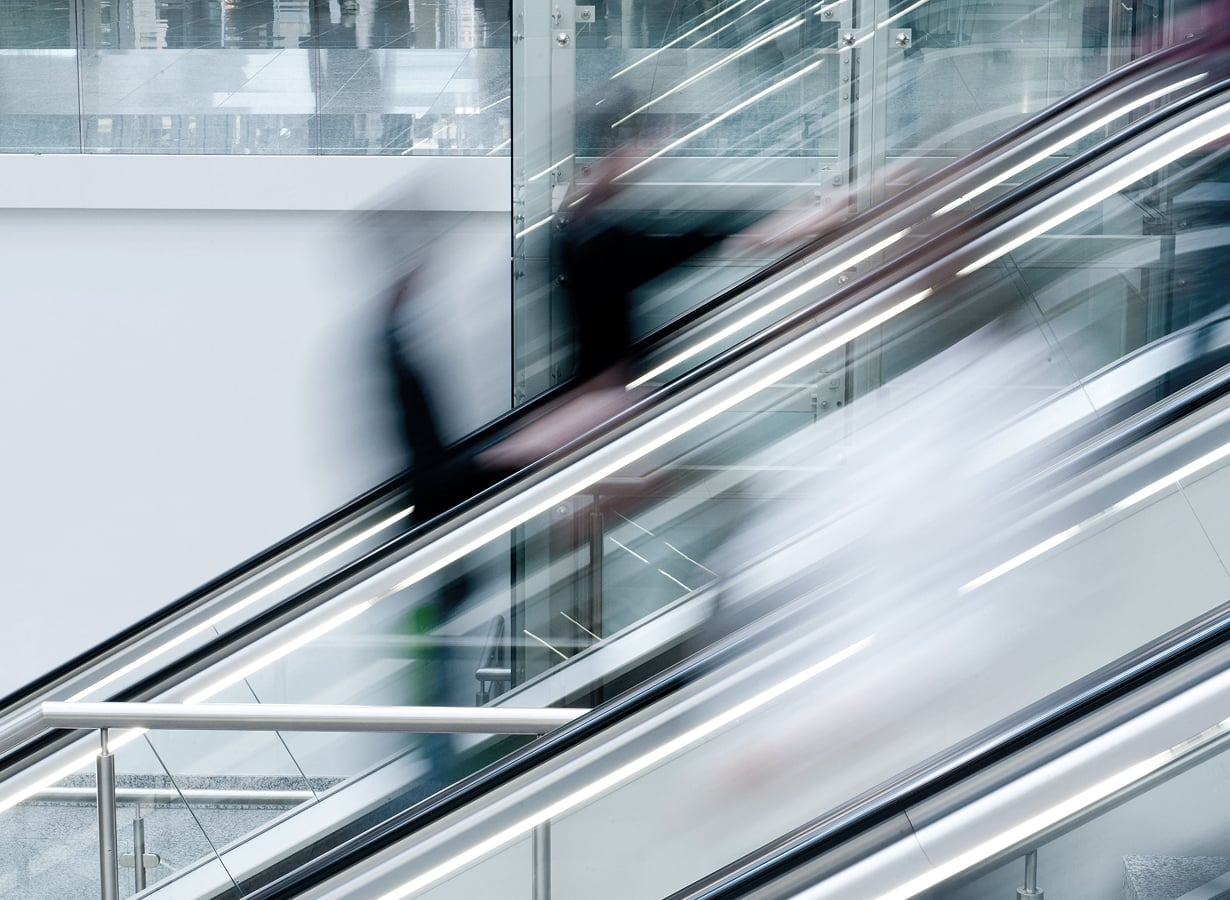 People moving through a modern office space symbolizing growth and momentum